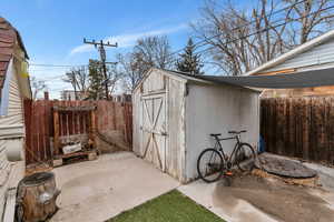 View of shed featuring a fenced backyard