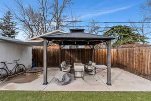 View of patio / terrace featuring a fenced backyard and a gazebo