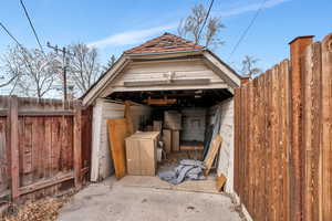 View of outdoor structure featuring fence