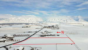 Snowy aerial view featuring a mountain view