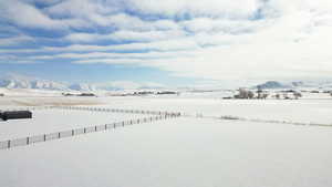 Yard covered in snow with a rural view and a mountain view