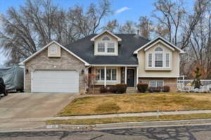 View of front of property with a garage and a front yard