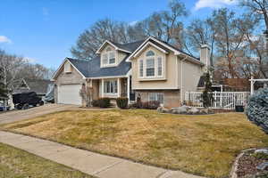 View of front of house featuring a garage and a front yard