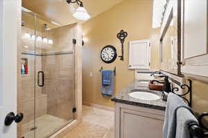 Master bathroom featuring vanity and a shower with door