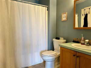 Full bathroom with vanity, toilet, and tile patterned floors