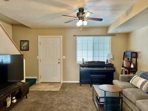 Living room with light carpet, ceiling fan, great traffic flow to bedrooms and kitchen area