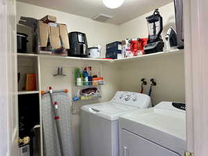 Laundry area, with ample room for washing machine and clothes dryer with shelves for storage