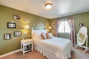 Bedroom with light carpet and baseboards