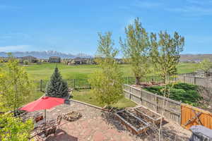 View of yard with a vegetable garden, a fenced backyard, and a mountain view