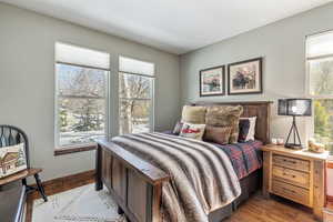 Bedroom with light wood-style floors and baseboards