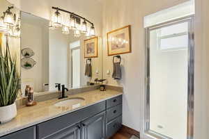 Bathroom with a stall shower and vanity