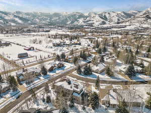 Snowy aerial view with a residential view and a mountain view