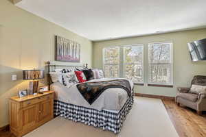 Bedroom featuring light wood finished floors, visible vents, and baseboards