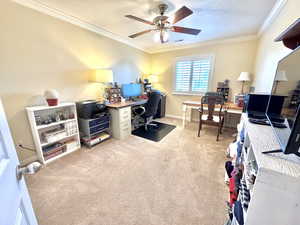 Bedroom 2 with light carpet, baseboards, ceiling fan, a textured ceiling, and crown molding