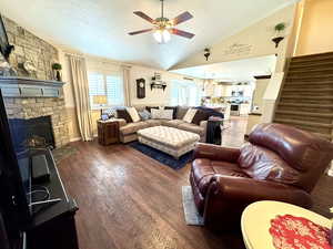 Living area featuring a wealth of natural light, dark wood-style flooring, and lofted ceiling