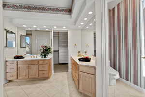 Full bathroom featuring recessed lighting, two vanities, a sink, and tile patterned floors