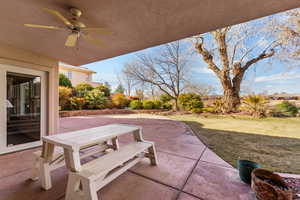 View of patio / terrace with outdoor dining space, fence, and a ceiling fan