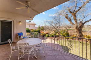 Balcony with outdoor dining space and ceiling fan