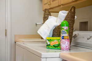 Washroom with laundry area and washing machine and clothes dryer