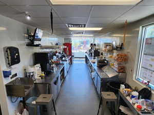 Miscellaneous room with a drop ceiling and a workshop area