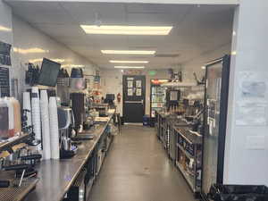Workout area with a drop ceiling and a workshop area