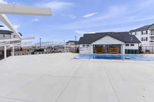 View of swimming pool with fence and a mountain view