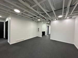 Below grade area featuring visible vents and baseboards