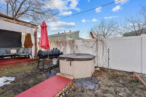 View of yard featuring fence private yard, a hot tub, and a deck