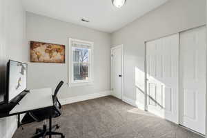 Office featuring carpet floors, baseboards, and visible vents