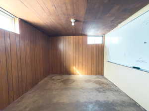 Basement with wood ceiling and wooden walls