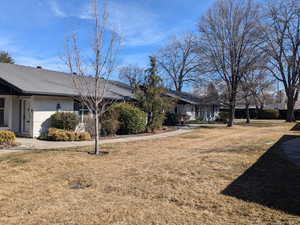 View of front facade with a front yard and brick siding