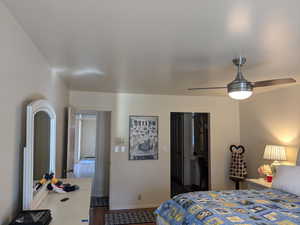 Bedroom featuring dark wood finished floors, ceiling fan, and baseboards