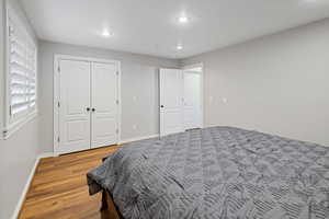 Bedroom with recessed lighting, baseboards, and wood finished floors