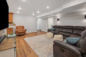 Living room with baseboards, recessed lighting, visible vents, and light wood-style floors