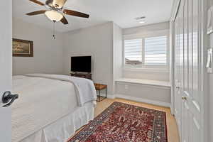 Bedroom with a ceiling fan, visible vents, and baseboards