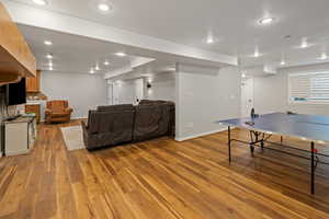 Playroom featuring baseboards, wood finished floors, and recessed lighting