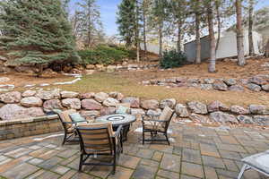 View of patio / terrace with an outdoor fire pit and fence