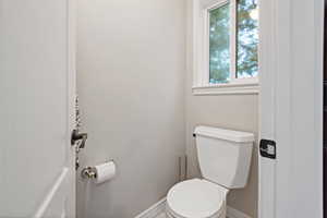 Bathroom featuring toilet and baseboards