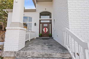 Entrance to property featuring brick siding