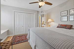 Bedroom with ceiling fan, a closet, and baseboards