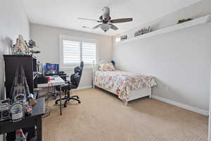 Bedroom with carpet floors, visible vents, ceiling fan, and baseboards