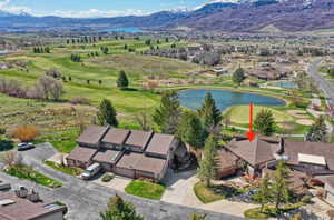 Birds eye view of property with a residential view and a water and mountain view