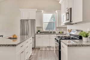 Kitchen featuring white cabinetry, stainless steel appliances, and a sink