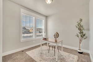 Home office featuring baseboards and visible vents