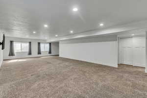 Basement with carpet floors, baseboards, and recessed lighting