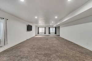 Spare room featuring recessed lighting, carpet, and baseboards