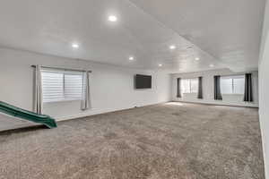 Empty room with recessed lighting, carpet flooring, and baseboards