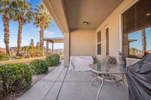 View of patio with area for grilling and a mountain view