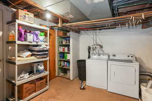 Washroom featuring laundry area and washer and dryer