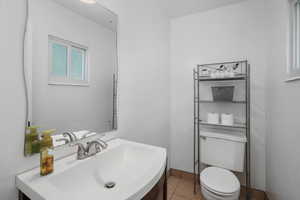 Bathroom with vanity, tile patterned flooring, and toilet